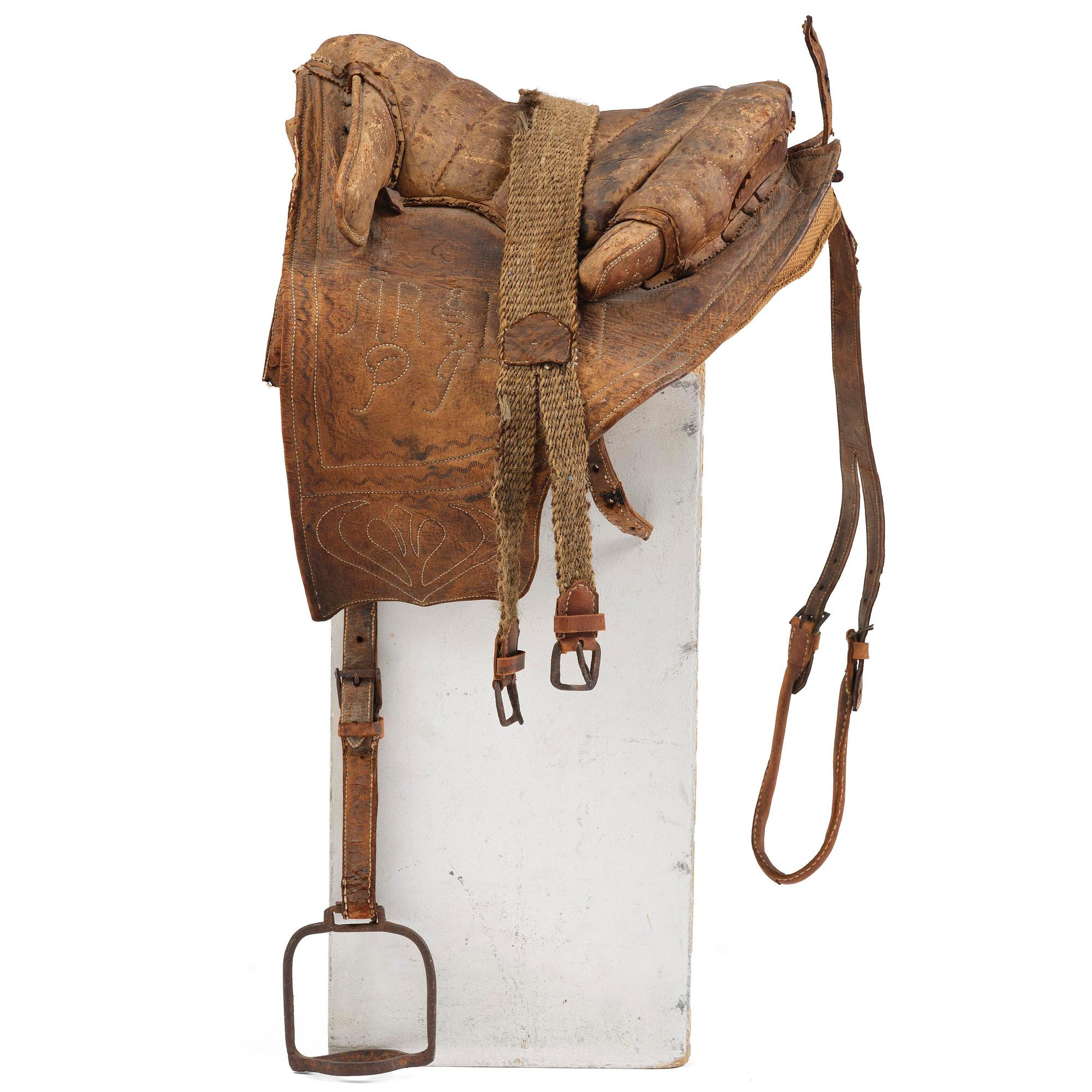 A leather saddle of Caucasian type, dated 1821.