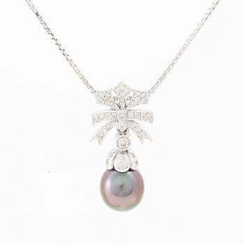 An 18K white gold necklace set with a drop-shaped cultured pearl and round brilliant-cut diamonds.