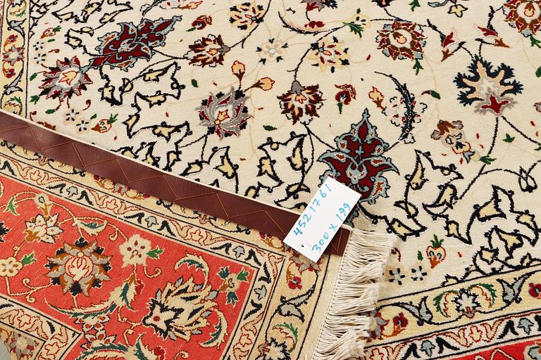 A Tabriz, part silk carpet, c. 300 x 199 cm.