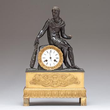 An Empire early 19th century gilt and patinated bronze mantel clock.