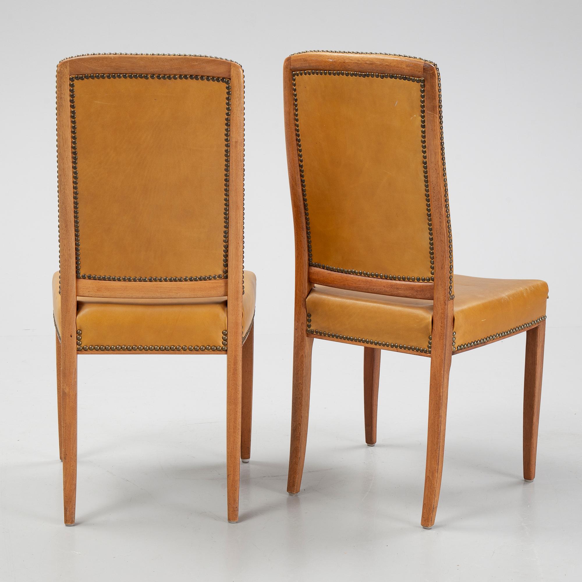 Carl Malmsten, a set of twelve, mahogany and leather chairs. Åfors Möbelfabrik.