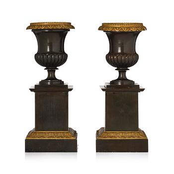 132. A pair of French Empire ormolu and patinated bronze urns, circa 1820.