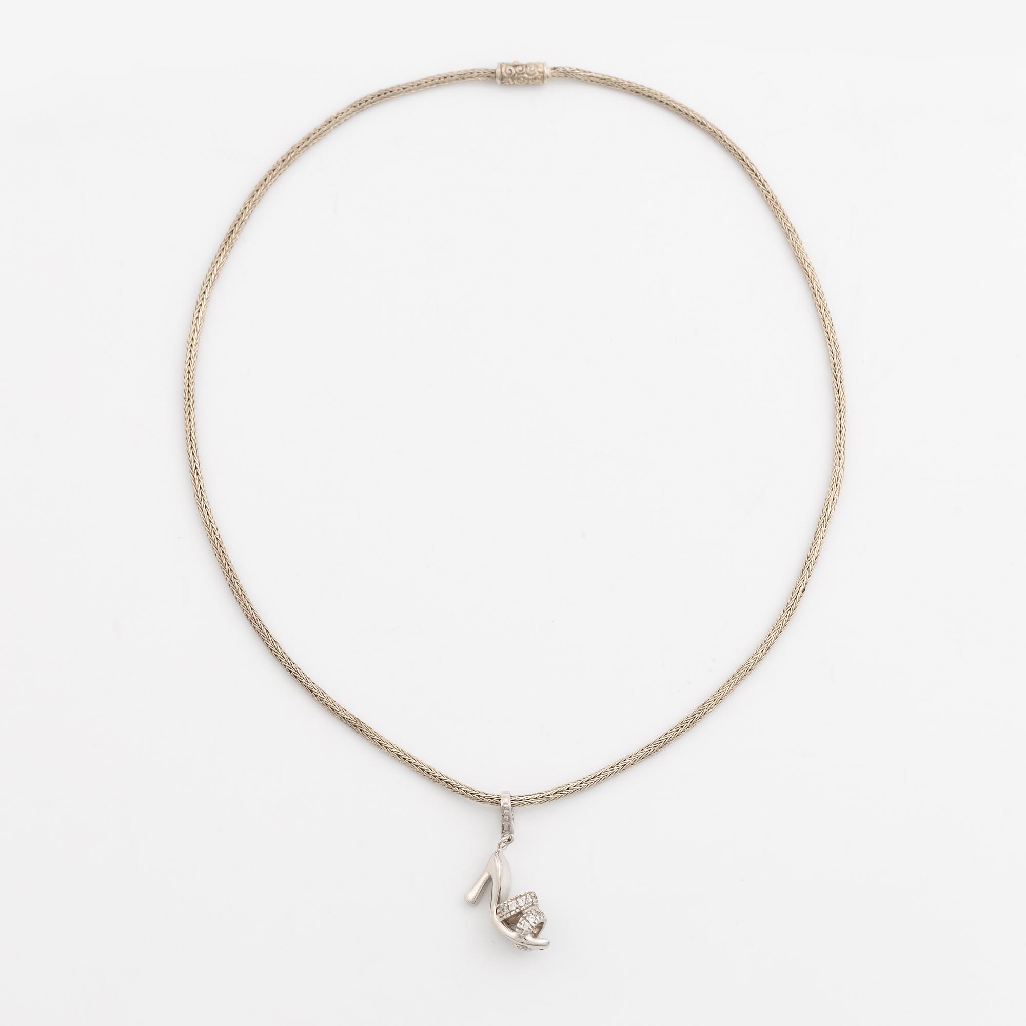 18K white gold shoe pendant with faceted white stones, silver chain.