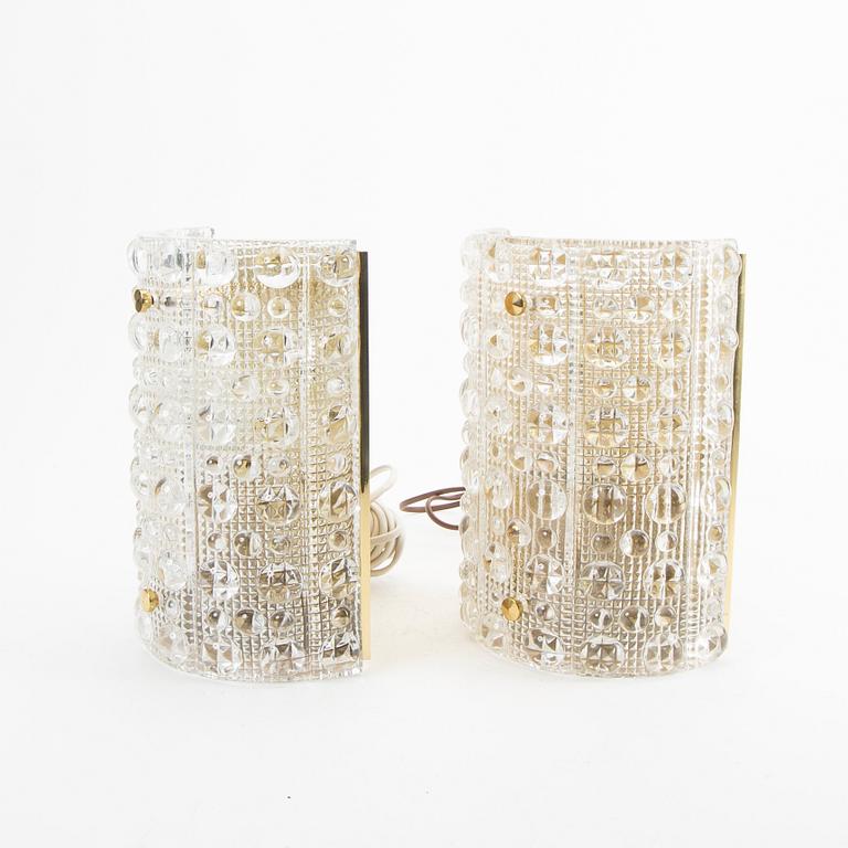 A pair of Carl Fagerlund glass and brass walls cones from Orrefors 1970s.