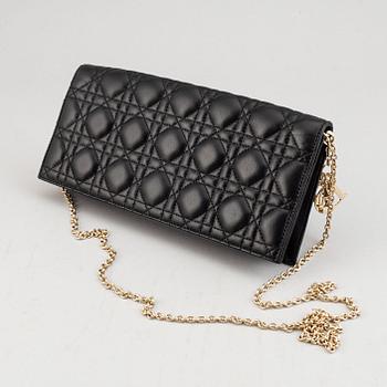 Christian Dior, a quilted leather handbag/clutch.