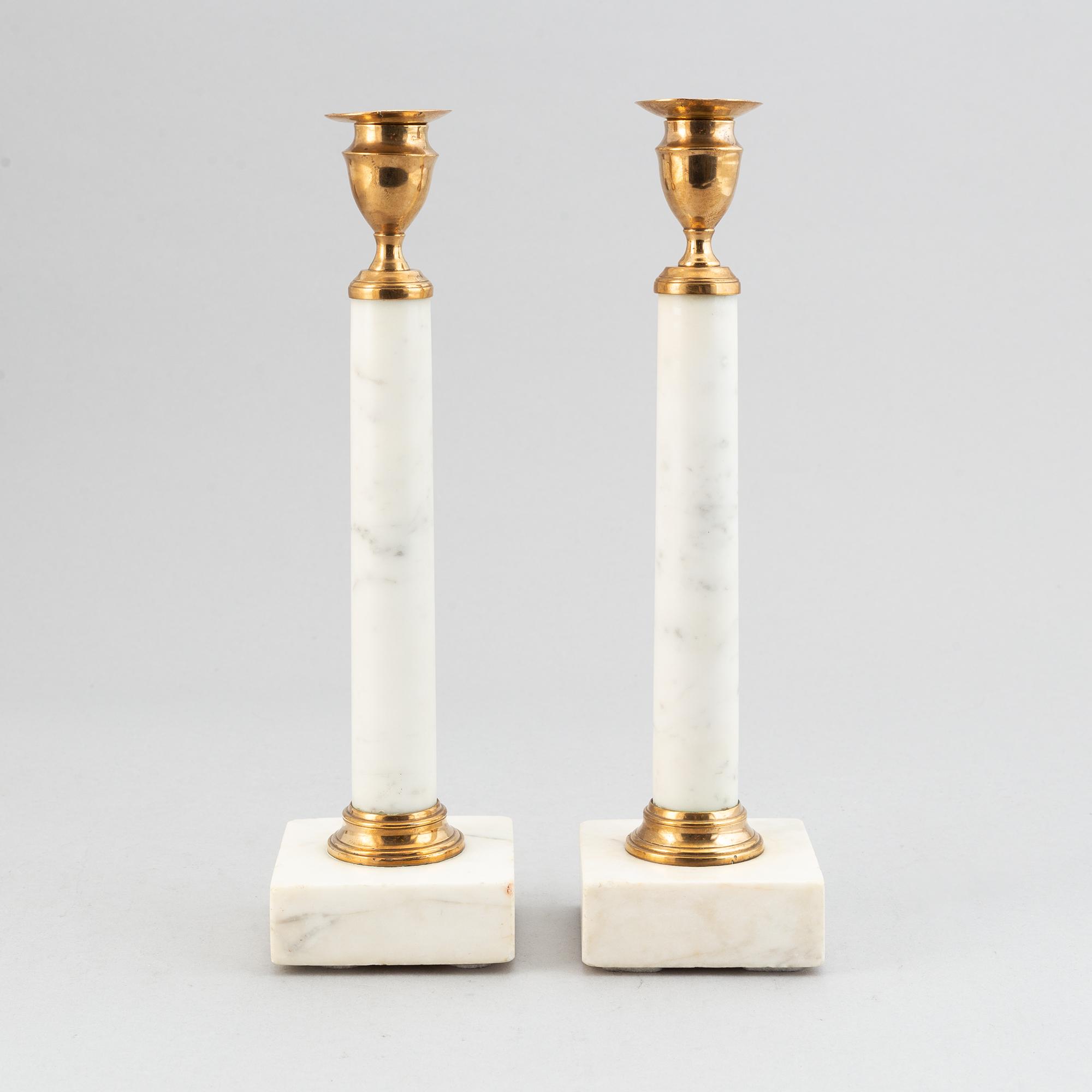 A pair of late Gustavian brass and cararra marble candle holders, around the year 1800.