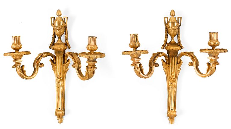 A pair of late 18th century Louis XVI gilt bronze two-light wall-lights.