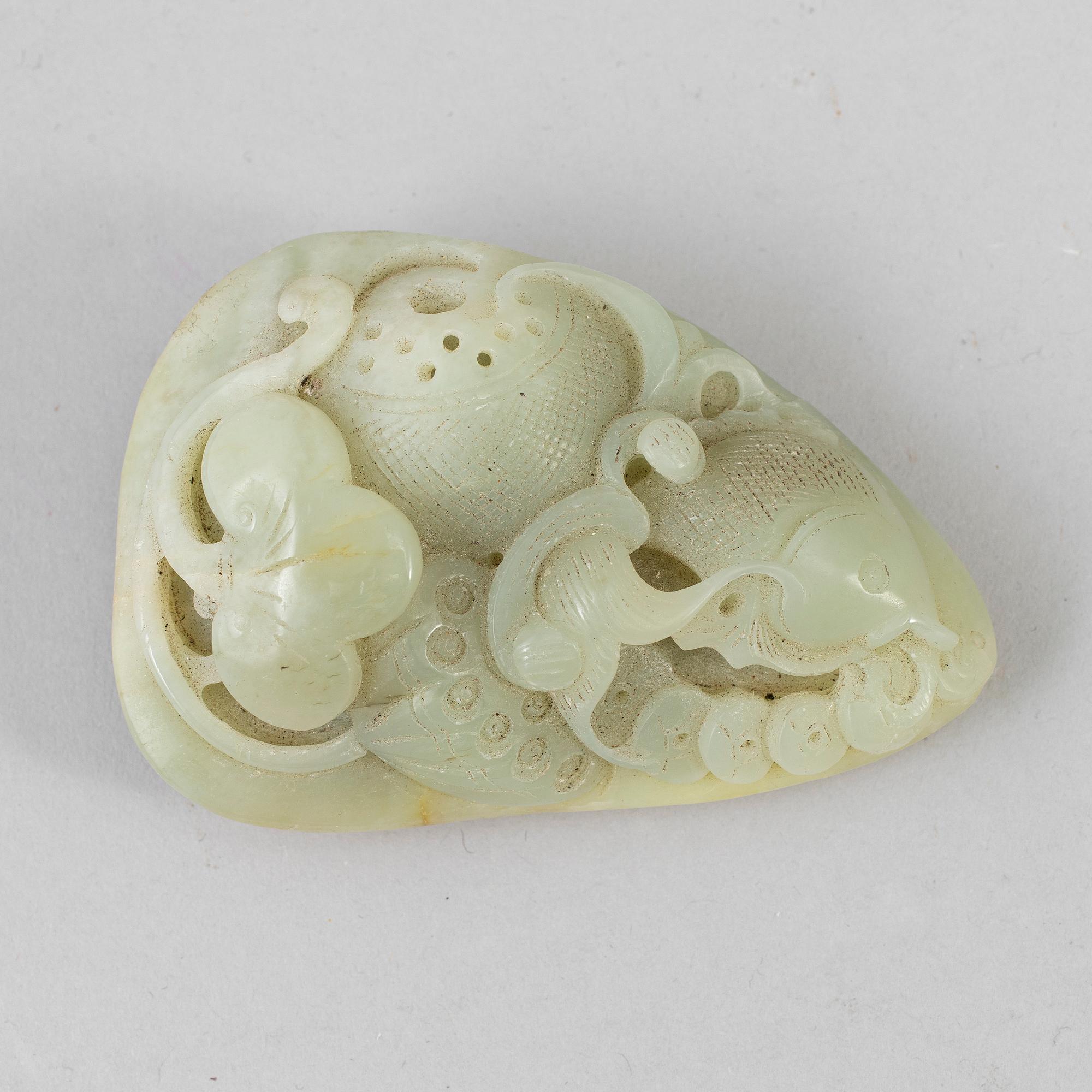 A carved stone sculpture of a fish in a lotus pond. China, 20th Century.