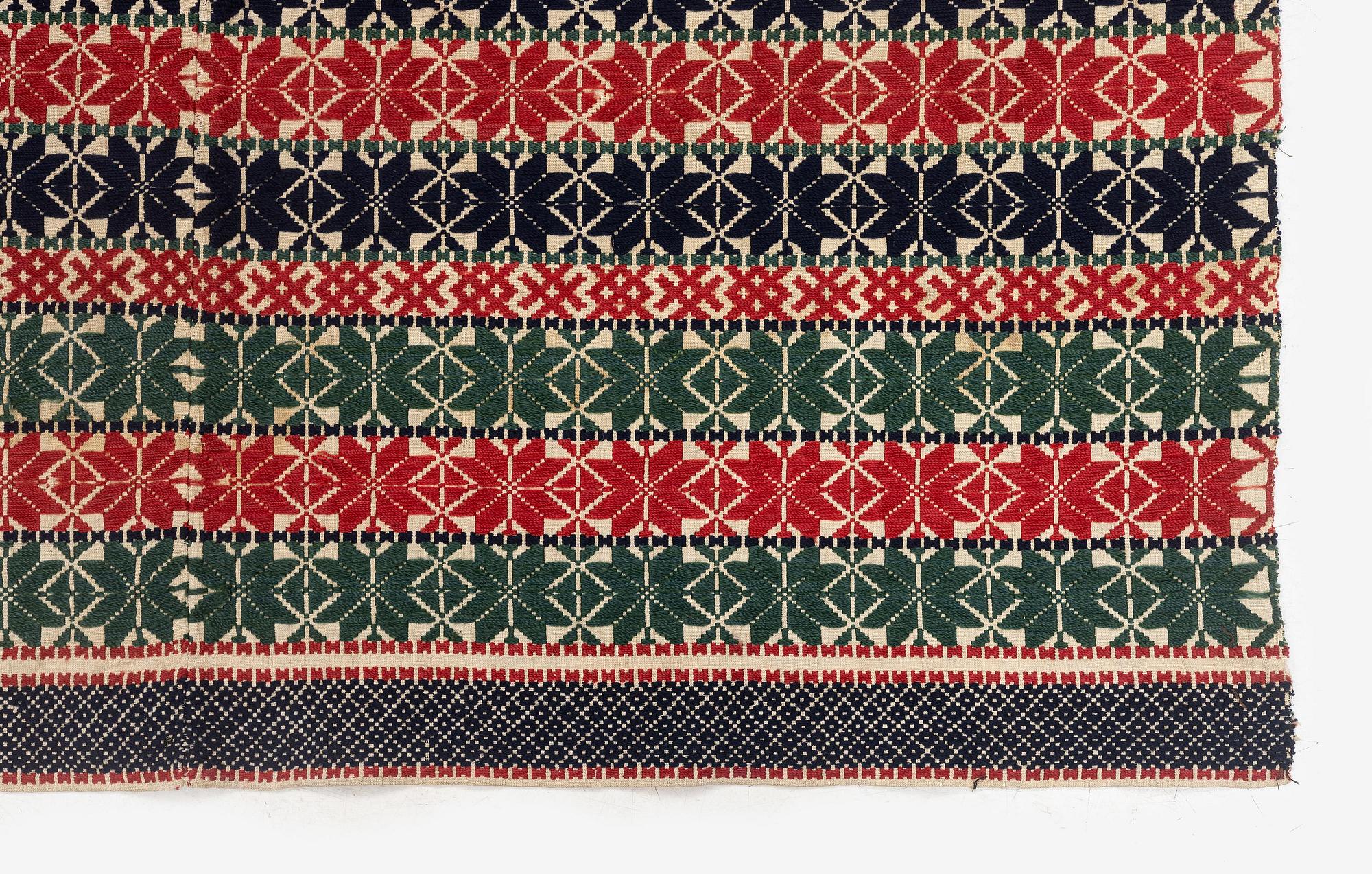 A bed cover in weft-patterned tabby type, c. 180 x 126, Scania, Sweden, first half of the 19th century.