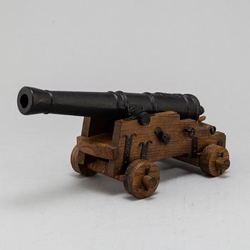 A 20th century cast iron signal cannon.