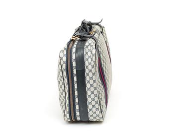 A travelling bag by Gucci.