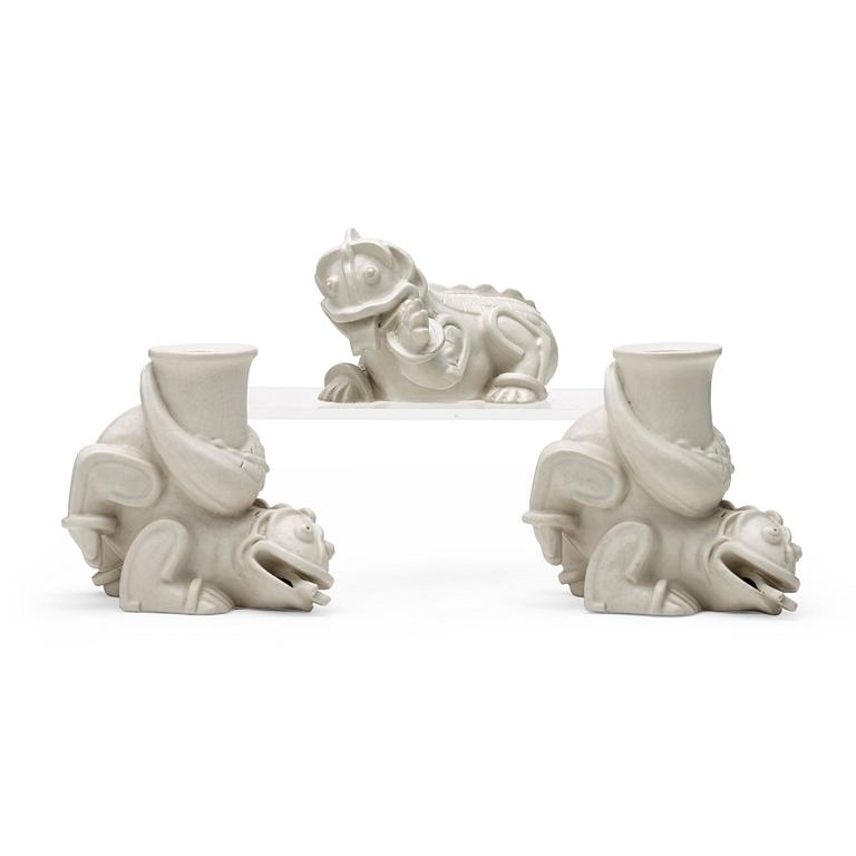 Wilhelm Kåge, a set of stoneware figures of a 'dragon puppy' and two 'dragon puppies' with candle holders, Gustavsberg, ca 1940.