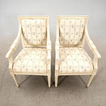 A pair of Gustavian style painted armchairs from around 1900.