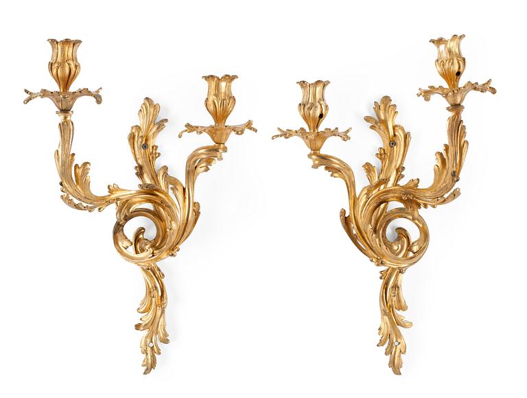 A pair of Louis XV-style 19th century gilt bronze two-light wall-lights.
