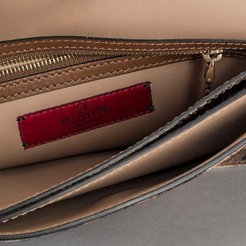 A ponyhair clutch with studs by Valentino.