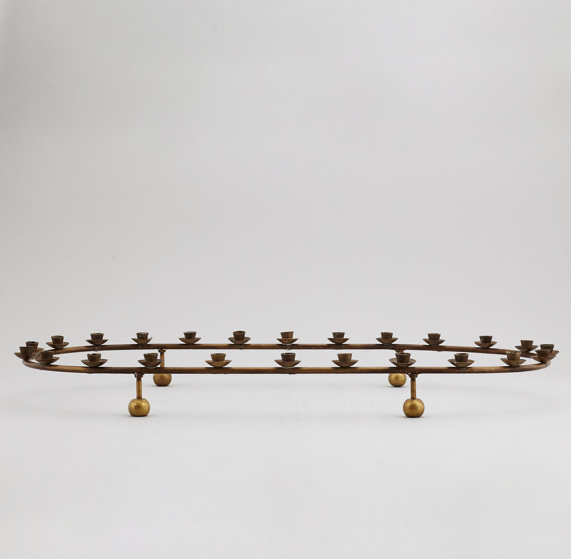 A mid 20th Century brass candle ring.