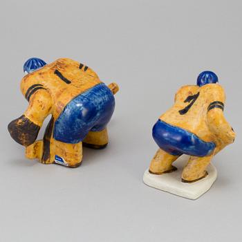 LISA LARSON, two stoneware figurines, "Ishockeyspelare", Gustavsberg. Designed in 1973.