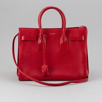 Saint Laurent, a red leather 'Sac du Jour Small' bag.