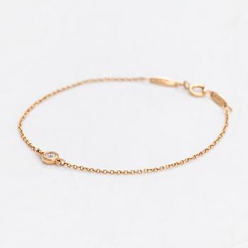Tiffany & Co, Elsa Peretti, an 18K gold bracelet with a brilliant cut diamond ca 0.07 ct.