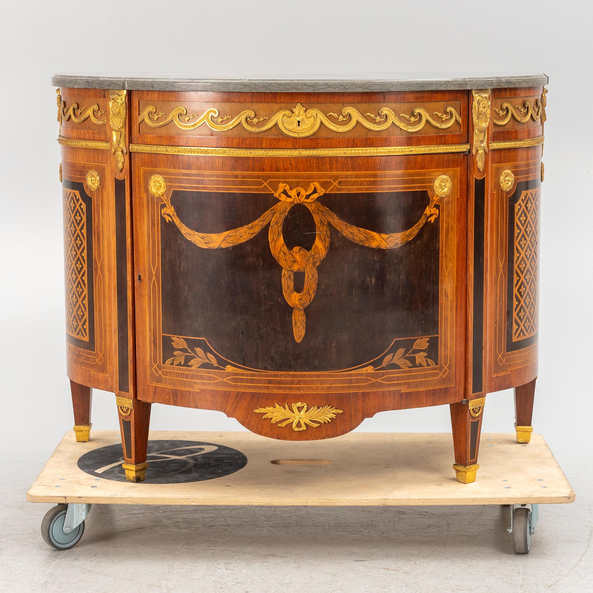 A Gustavian style cabinet with a stone top, 20th century.