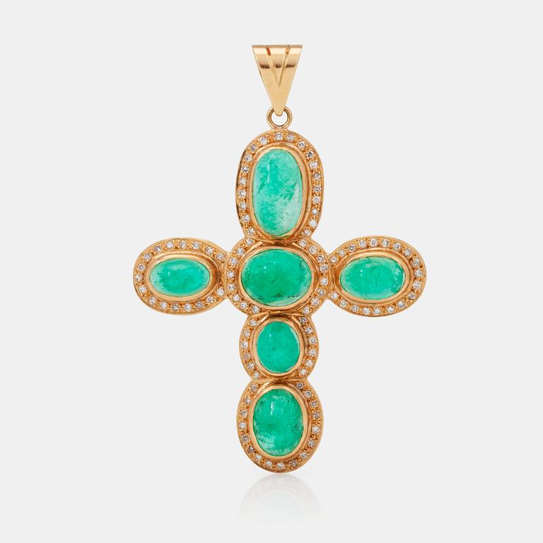 An emerald and diamond cross pendant.