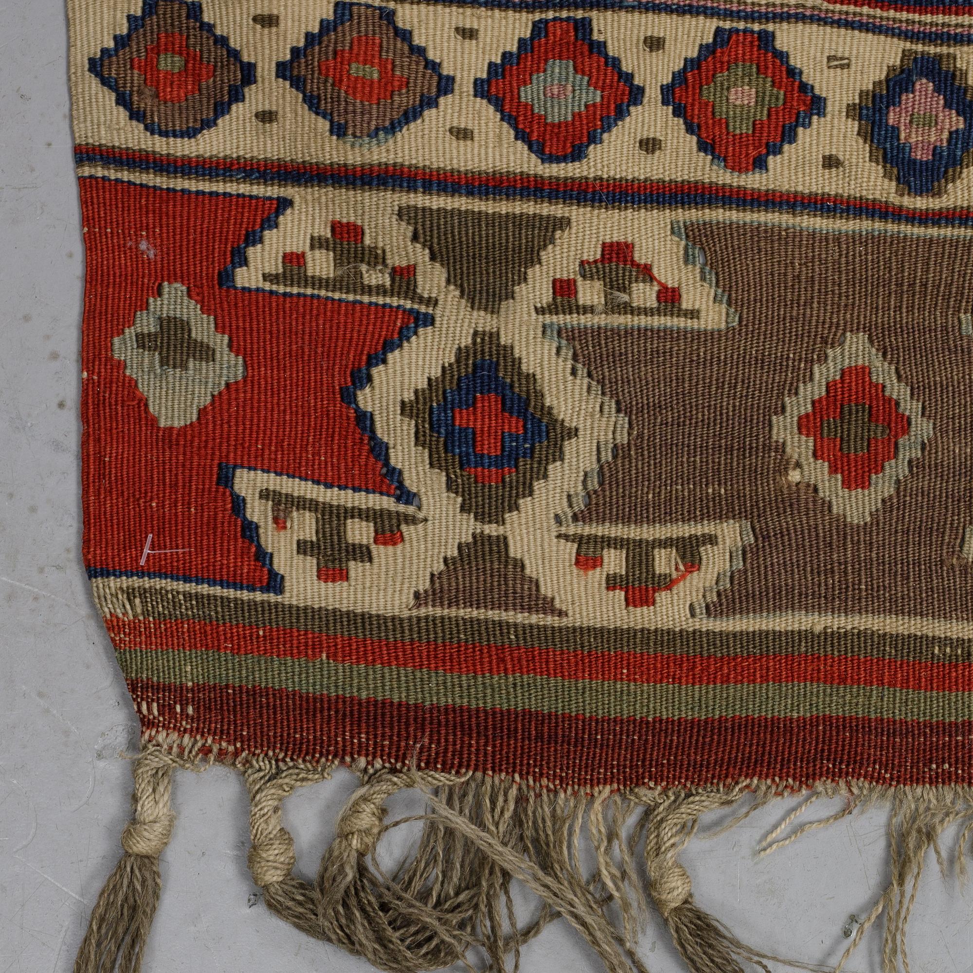 A carpet, a kilim, an antique Anatolian, ca 310-326 x 183,5-192 cm.