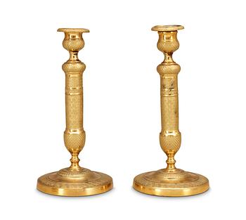 527. A pair of French Empire early 19th Century candlesticks.