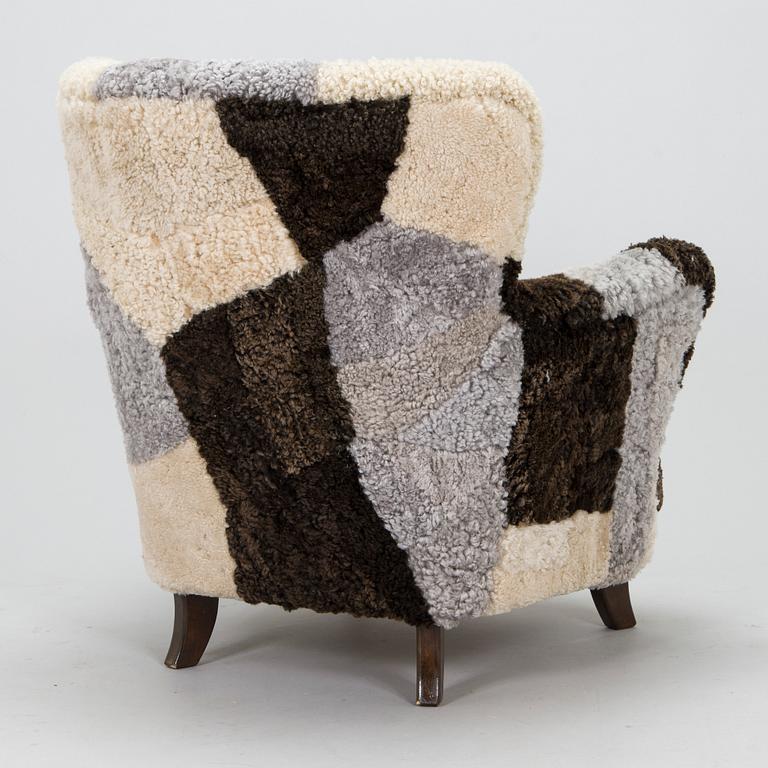 A 1950s lamb skin armchair.