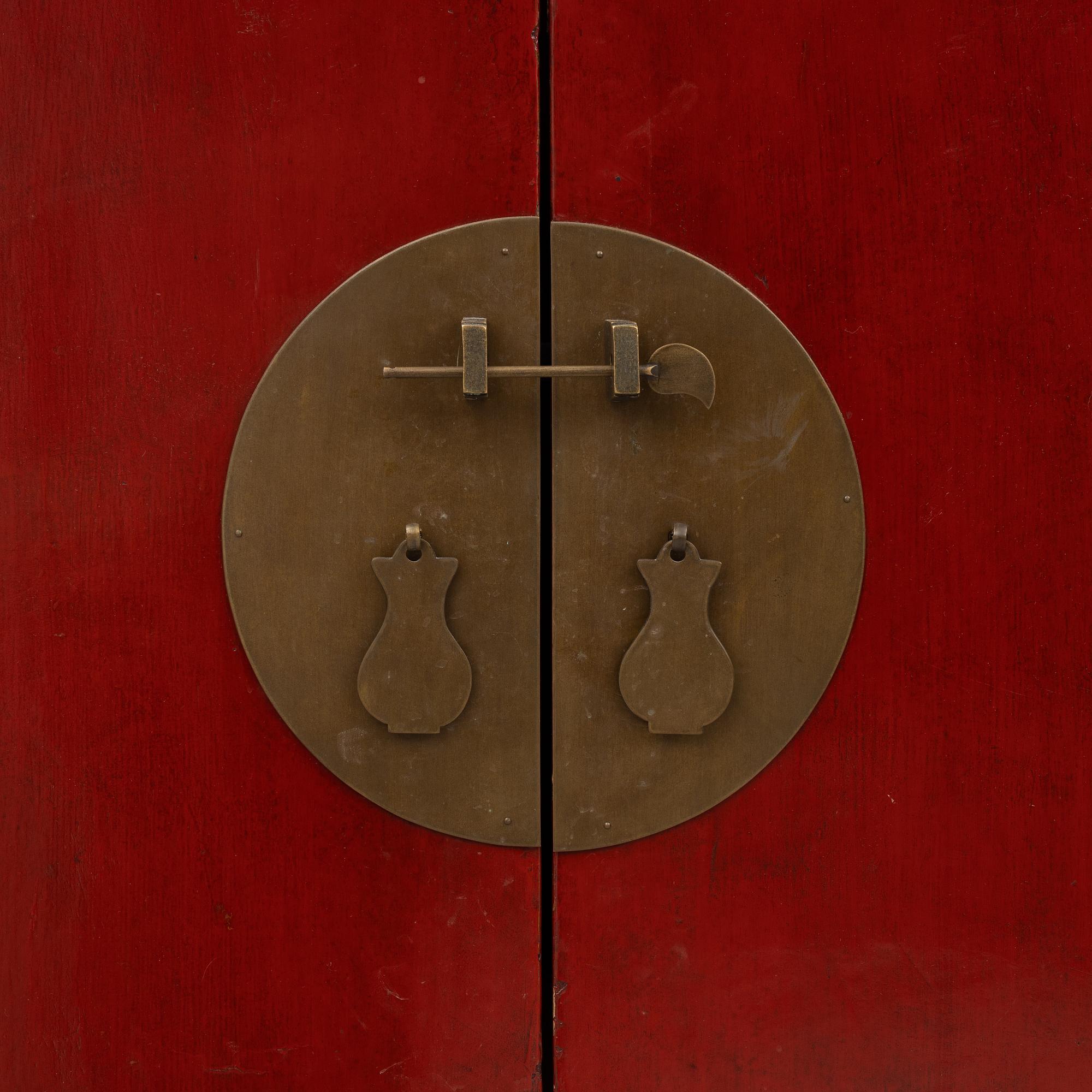 A red-lacquered cabinet, China, 20th century.