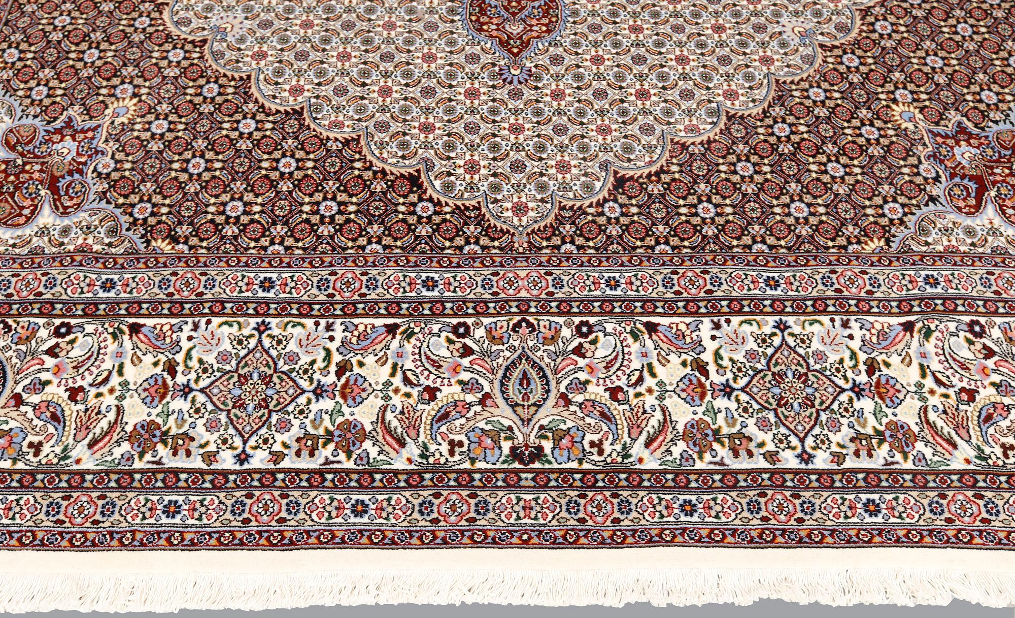 A part silk Moud carpet, approximately 350 x 252 cm.