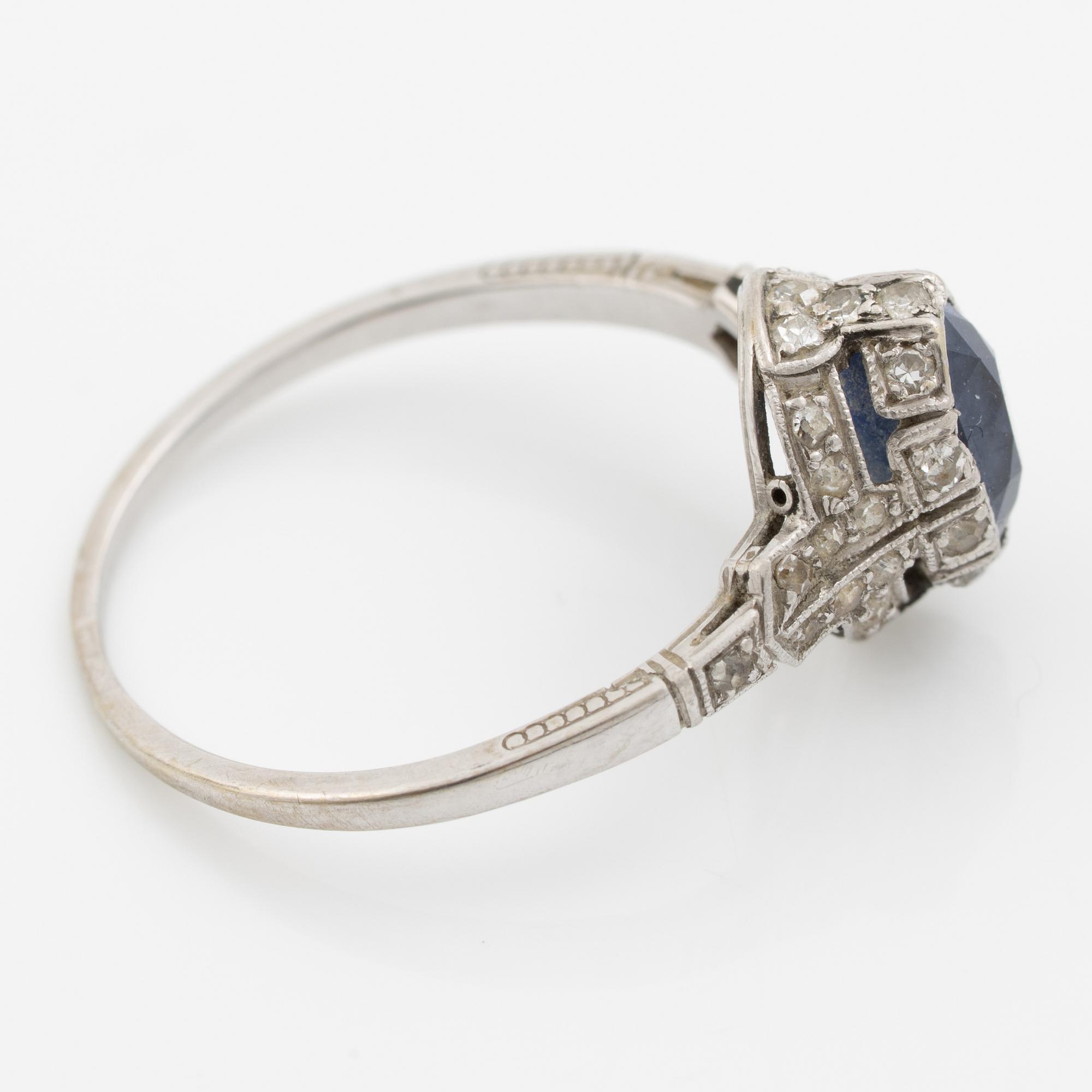 Ring 14K gold with a synthetic blue stone and small diamonds and white stones.