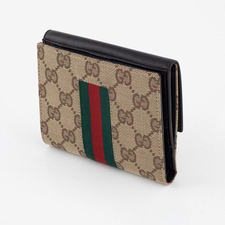 Gucci, a leather and canvas wallet, 1999.