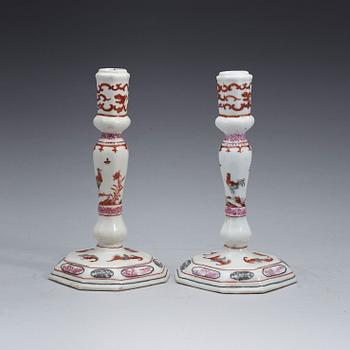 A pair of famille rose candle sticks, Qing dynasty, Qianlong (1736-95).