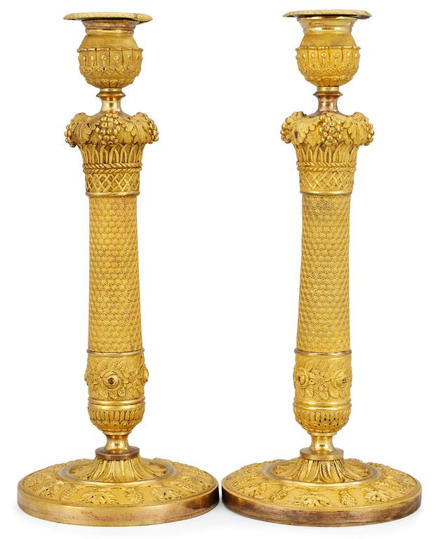 A pair of French Empire candlesticks.