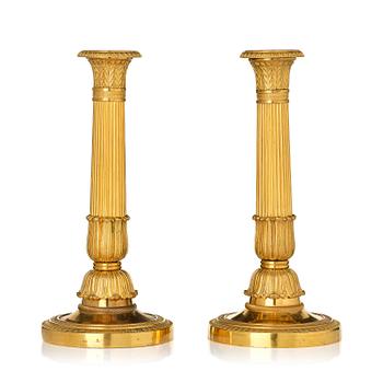 171. A pair of French Empire gilt-bronze candlesticks, early 19th century.