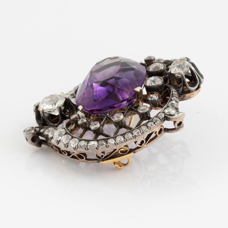 A brooch set with an amethyst and old-cut diamonds.
