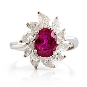 A ring set with a faceted ruby and navette-cut diamonds.