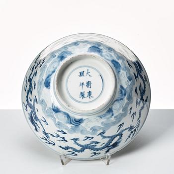 A blue and white four clawed dragon bowl, Qing dynasty, with Kangxis six character mark and period.