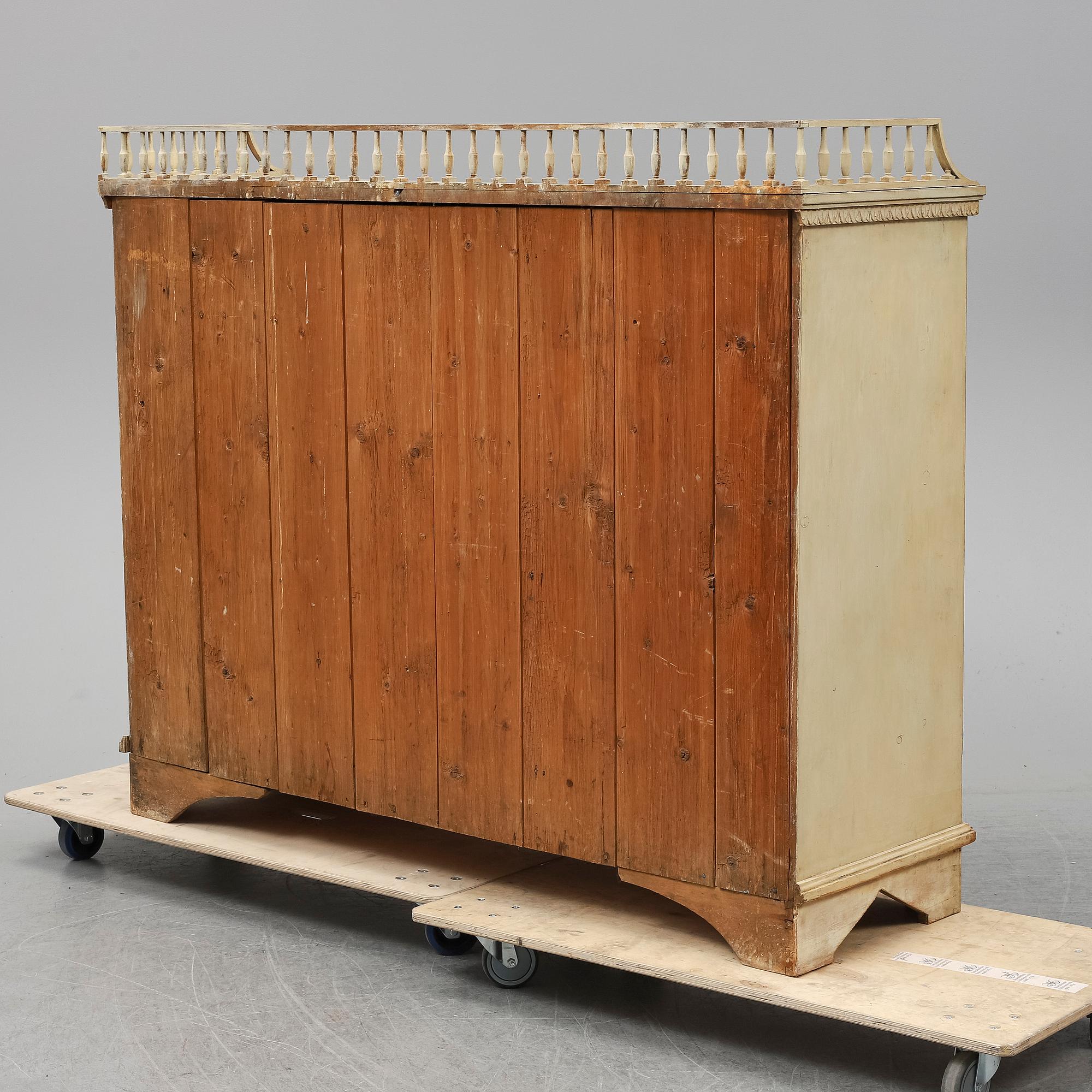 An early 19th Century painted late Gustavian cupboard.