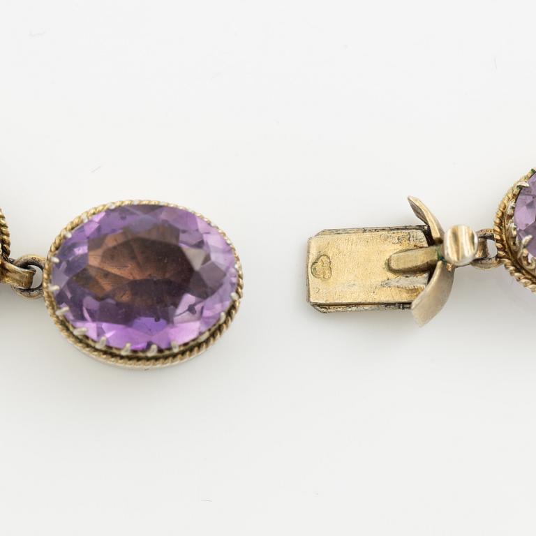 Garniture, necklace and bracelet silver with amethysts, brooch gold-coloured metal with purple paste stones,