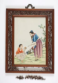 A plaque with enameled decor of man and boy with geese, Qing Dynasty, early 20th Century.