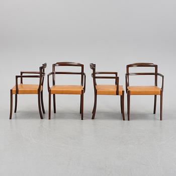 A set of four black stained beech tree arm chairs with leather upholstery, second half of the 20th century.