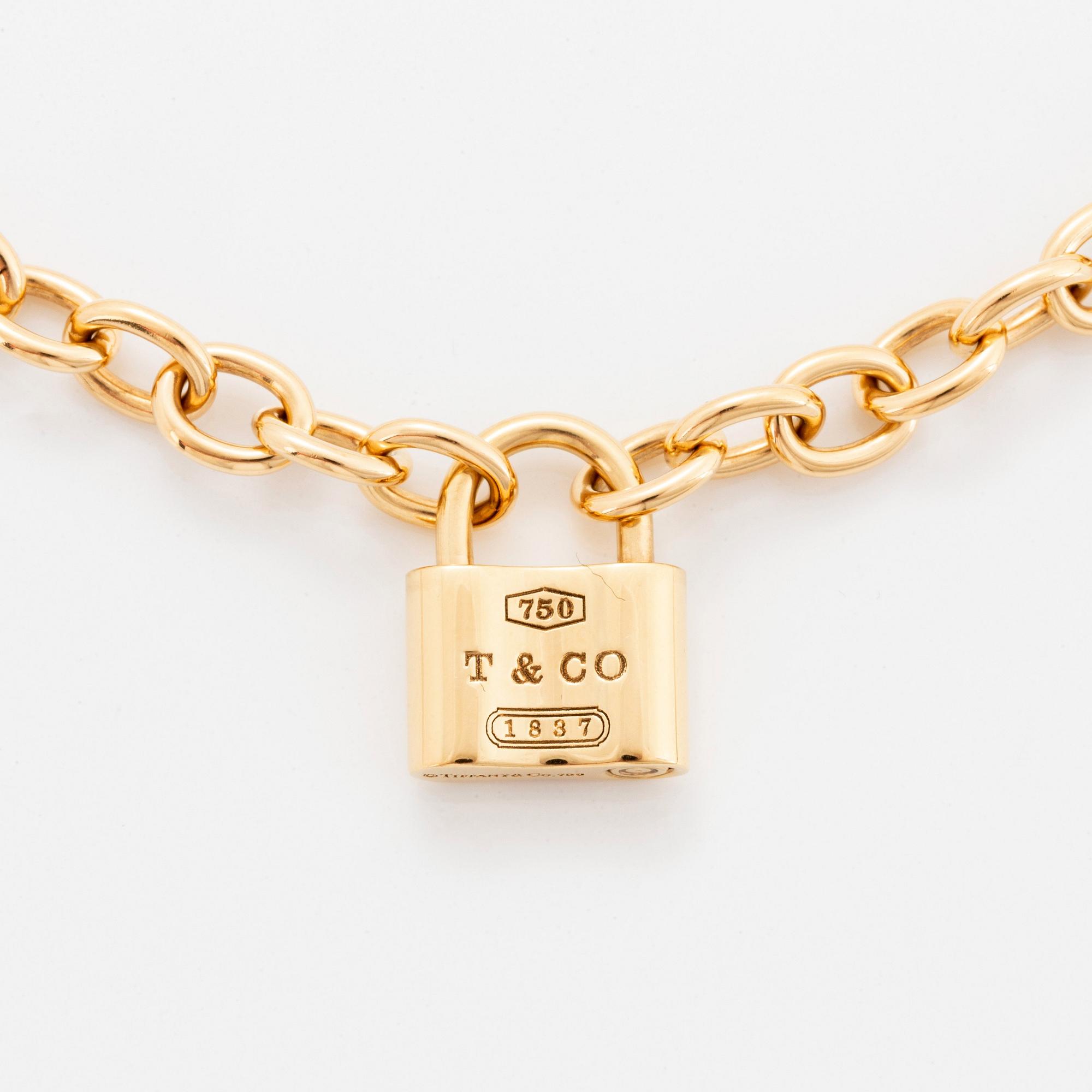 A Tiffany lock charm pendant necklace 1837 in 18K gold. Bukowskis