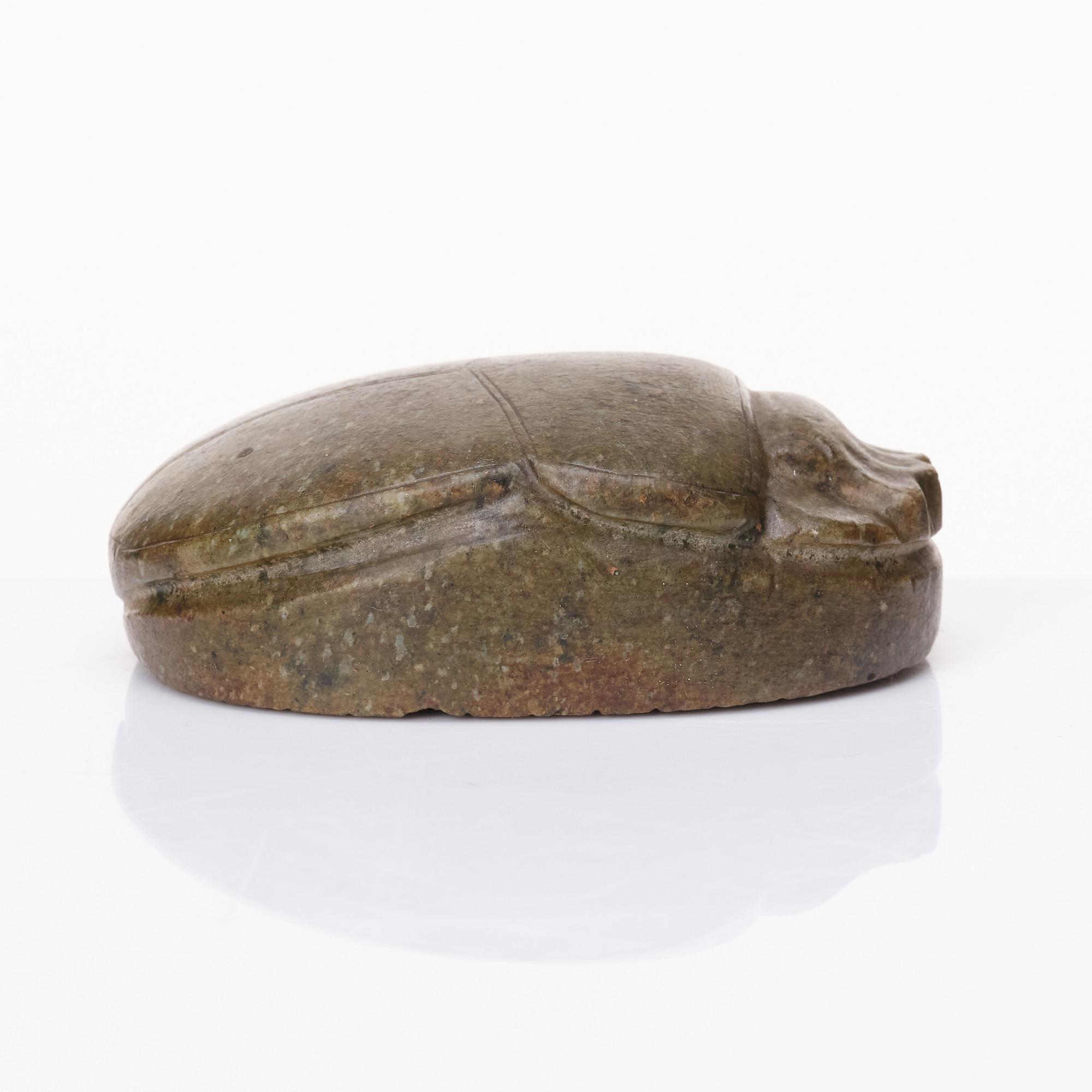 An Egyptian hardstone funerary scarab, probably Late Period, 26th-30th Dynasties, circa 664-343 B.C.