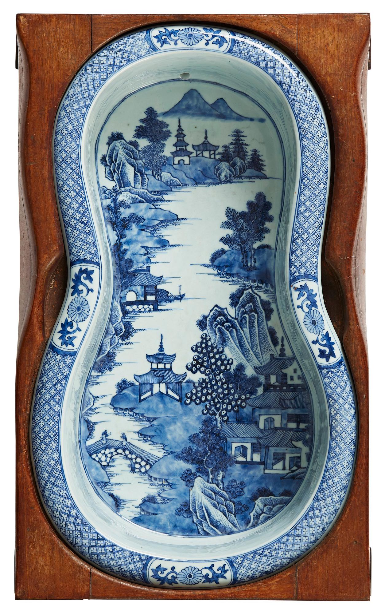 A blue and white bidet with a wooden stand, Qing dynasty, Qianlong (1736-95).