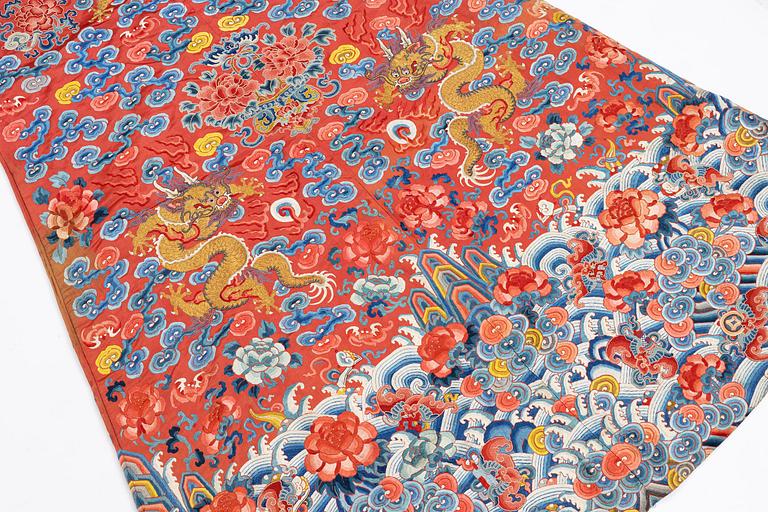 An embroidered red ground five clawed dragon 'female' formal robe, Qing dynasty, 19th century.