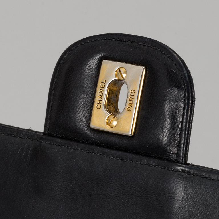 CHANEL, a quilted black leather 'Double Flap Bag'.