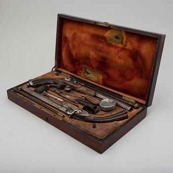 A pair of mid 19th century percussion pistols in a case marked Campagnac a Bordeaux.