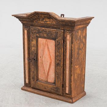 A late Baroque painted wall cabinet, dated 1757.