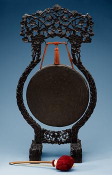 A bronze gong with a wooden stand, Qing dynasty.